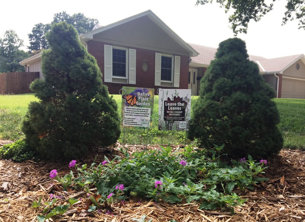 Exterior of home with native plant signs