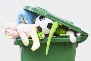 Unwanted toys in a recycling bin